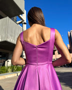 Rochie scurta evazată din satin cu decolteu ascuțit și fermoar.