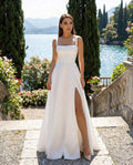 Long white wedding dress with an elegant and refined slit, made of satin