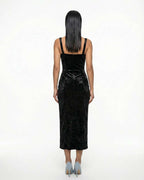 Black velvet bodycon dress with straps, slit, and elegant neckline